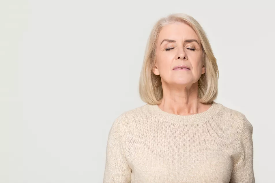 Relaxed middle-aged woman breathing slowly